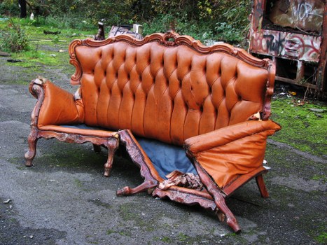 Van and skips at a residential driveway representing insured rubbish services